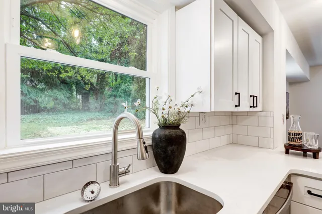 a kitchen with a sink and a large window