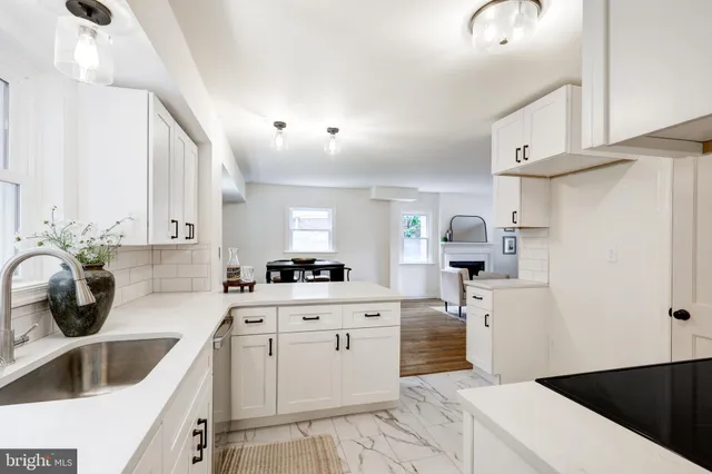 a kitchen with white cabinets sink and white appliances