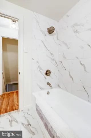 a bathroom with a bathtub and shower