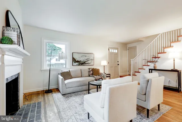 a living room with furniture a fireplace and a table
