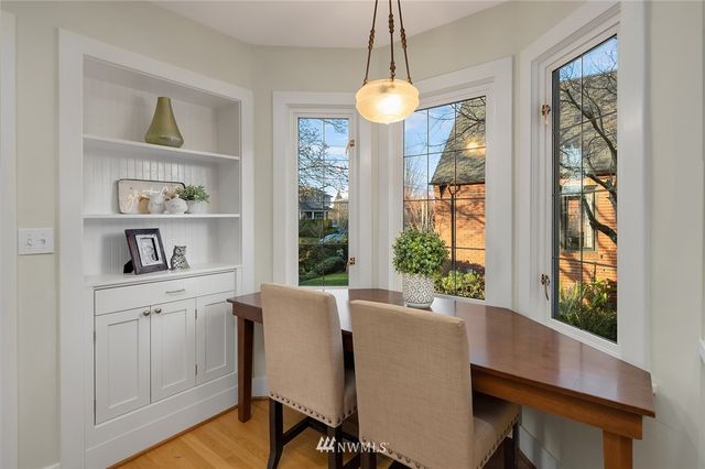 a view of a dining room with furniture window and wooden floor