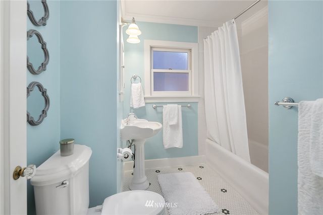 a bathroom with a shower toilet and sink