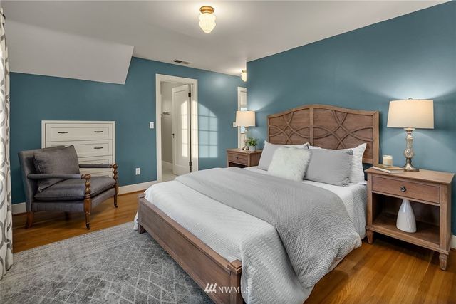 a bedroom with a bed and a chair