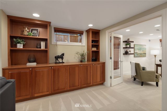 a living room with furniture a rug and kitchen view