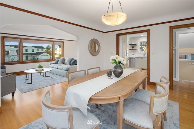 a living room with fireplace furniture and a large window
