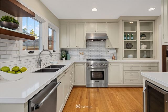 a kitchen with a sink stove and cabinets