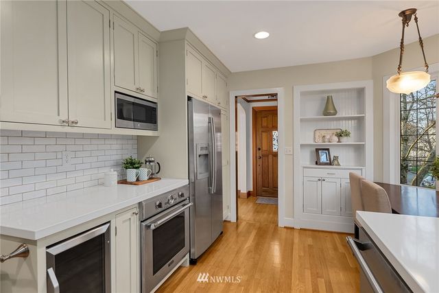 a kitchen with a sink a stove and cabinets