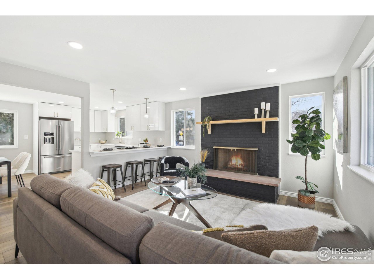 1310 Toedtli Drive Boulder, CO 80305 - Photo 11 of 40 a living room with furniture a fireplace and a potted plant