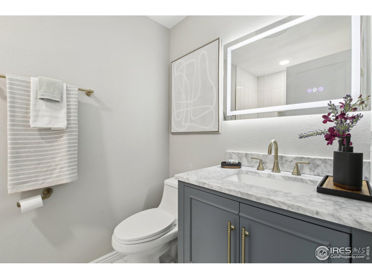 1310 Toedtli Drive Boulder, CO 80305 - Photo 12 of 40 a bathroom with a granite countertop sink mirror and a toilet
