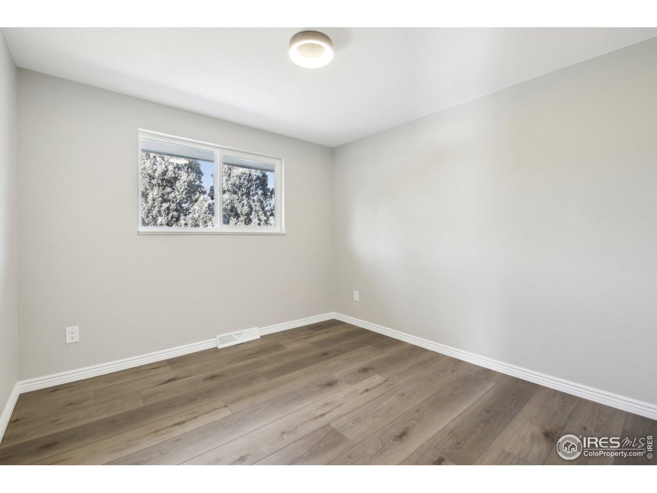 1310 Toedtli Drive Boulder, CO 80305 - Photo 15 of 40 an empty room with wooden floor