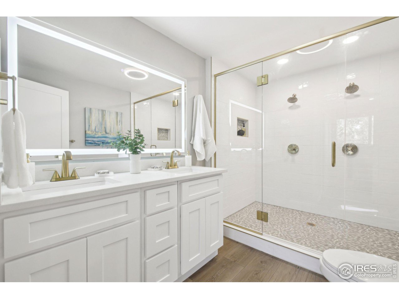 1310 Toedtli Drive Boulder, CO 80305 - Photo 18 of 40 a bathroom with a double vanity sink a toilet a mirror and shower