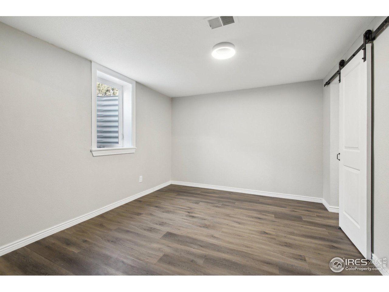 1310 Toedtli Drive Boulder, CO 80305 - Photo 27 of 40 a view of an empty room with wooden floor and a window