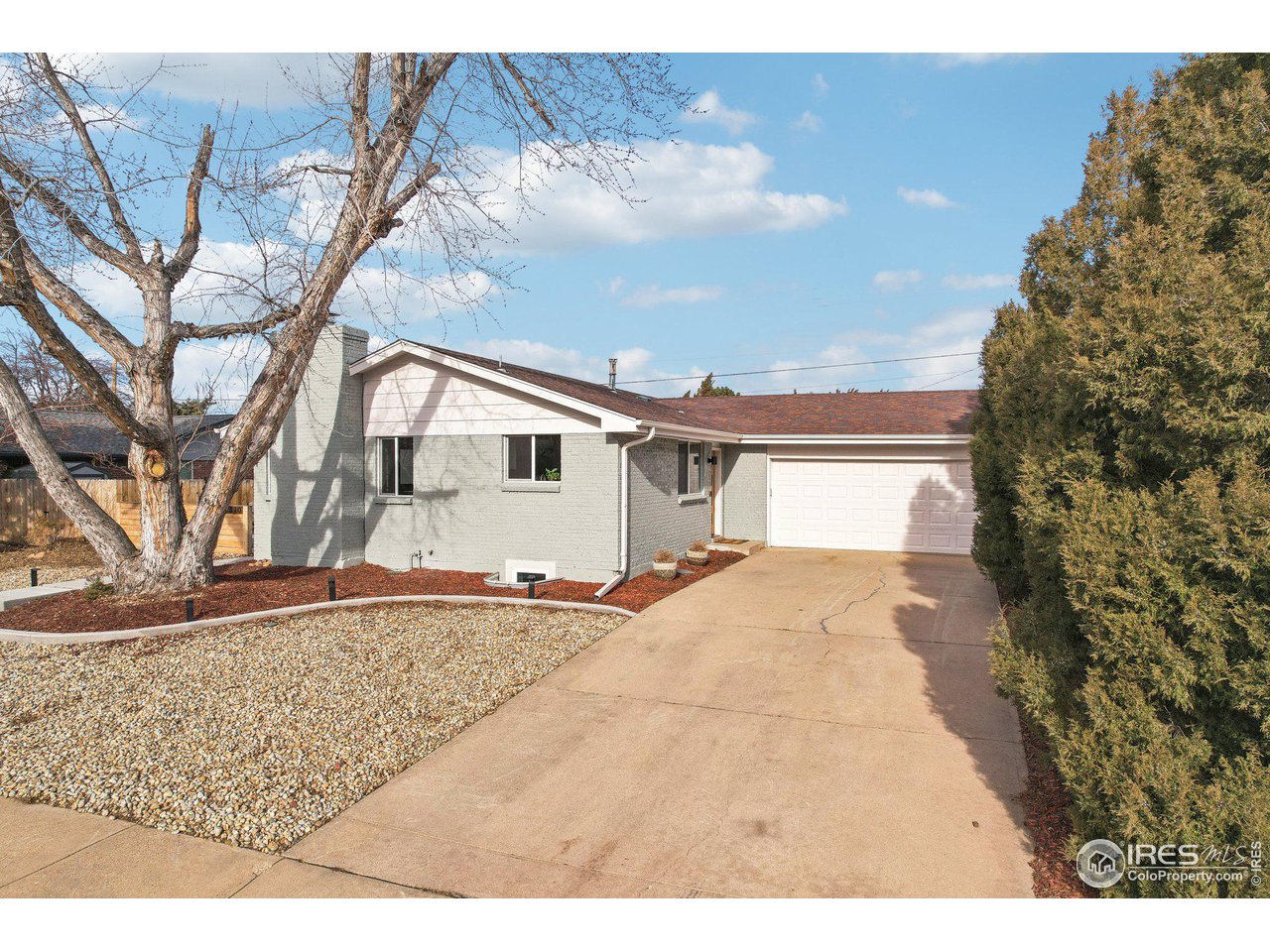 1310 Toedtli Drive Boulder, CO 80305 - Photo 32 of 40 a white house with a large tree in front of it