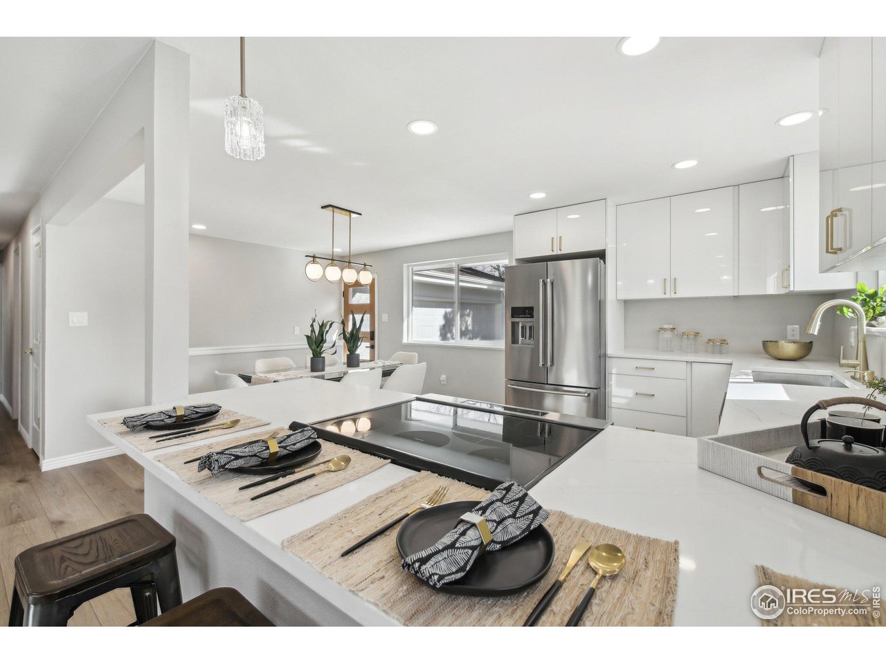1310 Toedtli Drive Boulder, CO 80305 - Photo 4 of 40 a kitchen with a stove a refrigerator and a sink with wooden floor