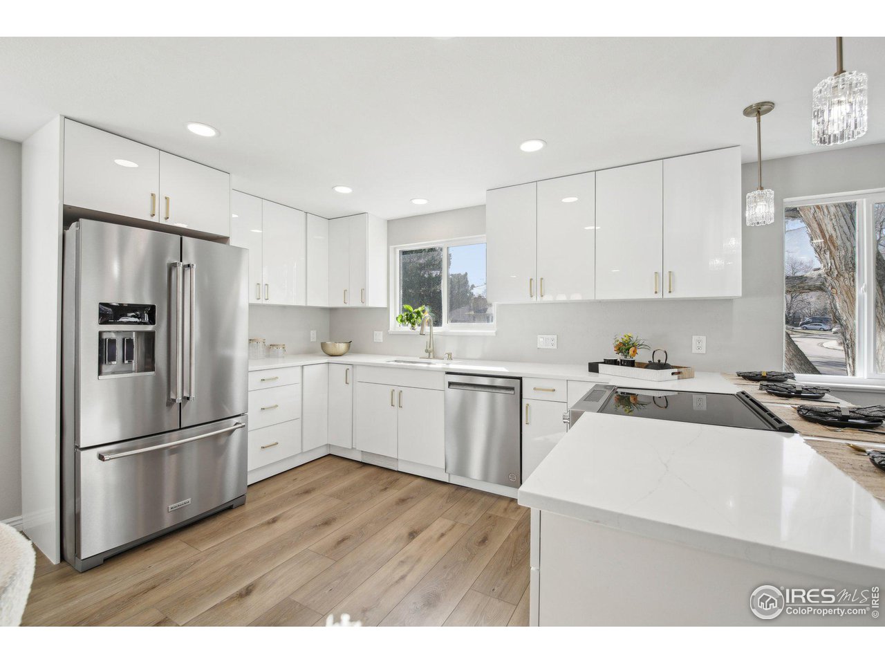 1310 Toedtli Drive Boulder, CO 80305 - Photo 7 of 40 a kitchen with a refrigerator a sink and cabinets