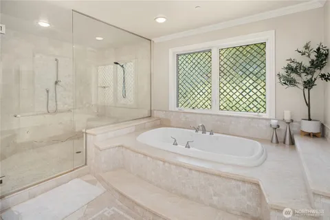 a bathroom with a bathtub and a shower