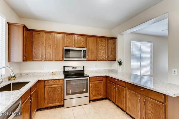 a kitchen with sink a microwave and cabinets
