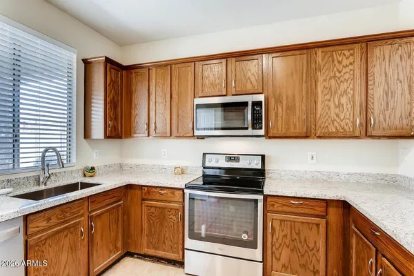 a kitchen with stainless steel appliances granite countertop a sink stove and microwave