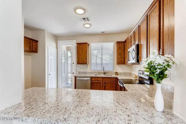 a kitchen with a refrigerator and a sink