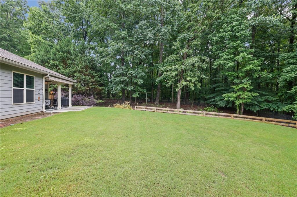 6255 Allison Road Cumming, GA 30040 - Photo 31 of 36 a view of a house with a backyard