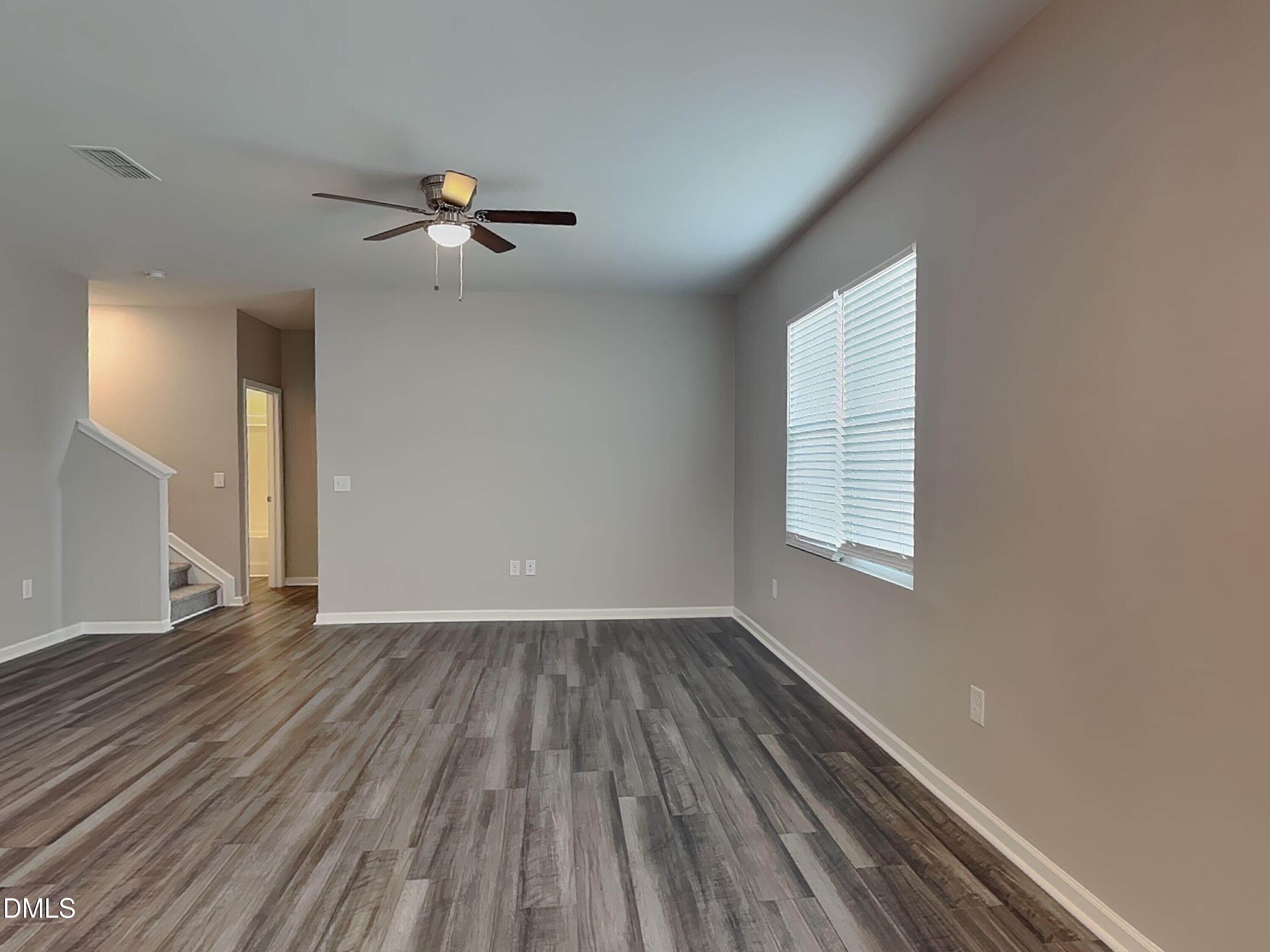 1416 Justice Union Court Raleigh, NC 27604 - Photo 2 of 16 wooden floor in an empty room with a window