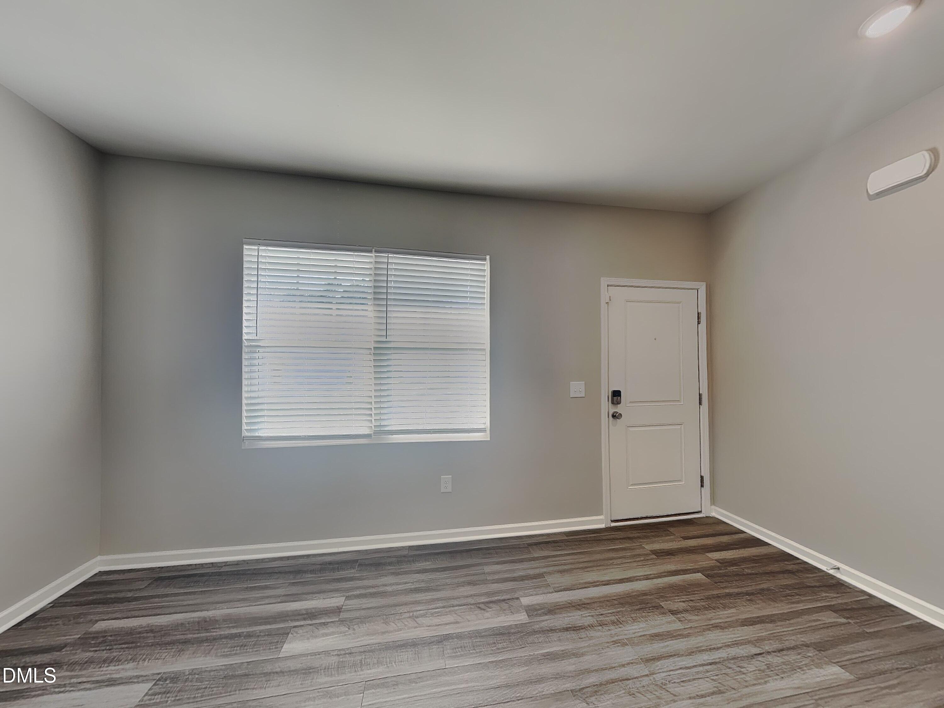 1416 Justice Union Court Raleigh, NC 27604 - Photo 4 of 16 an empty room with wooden floor and windows