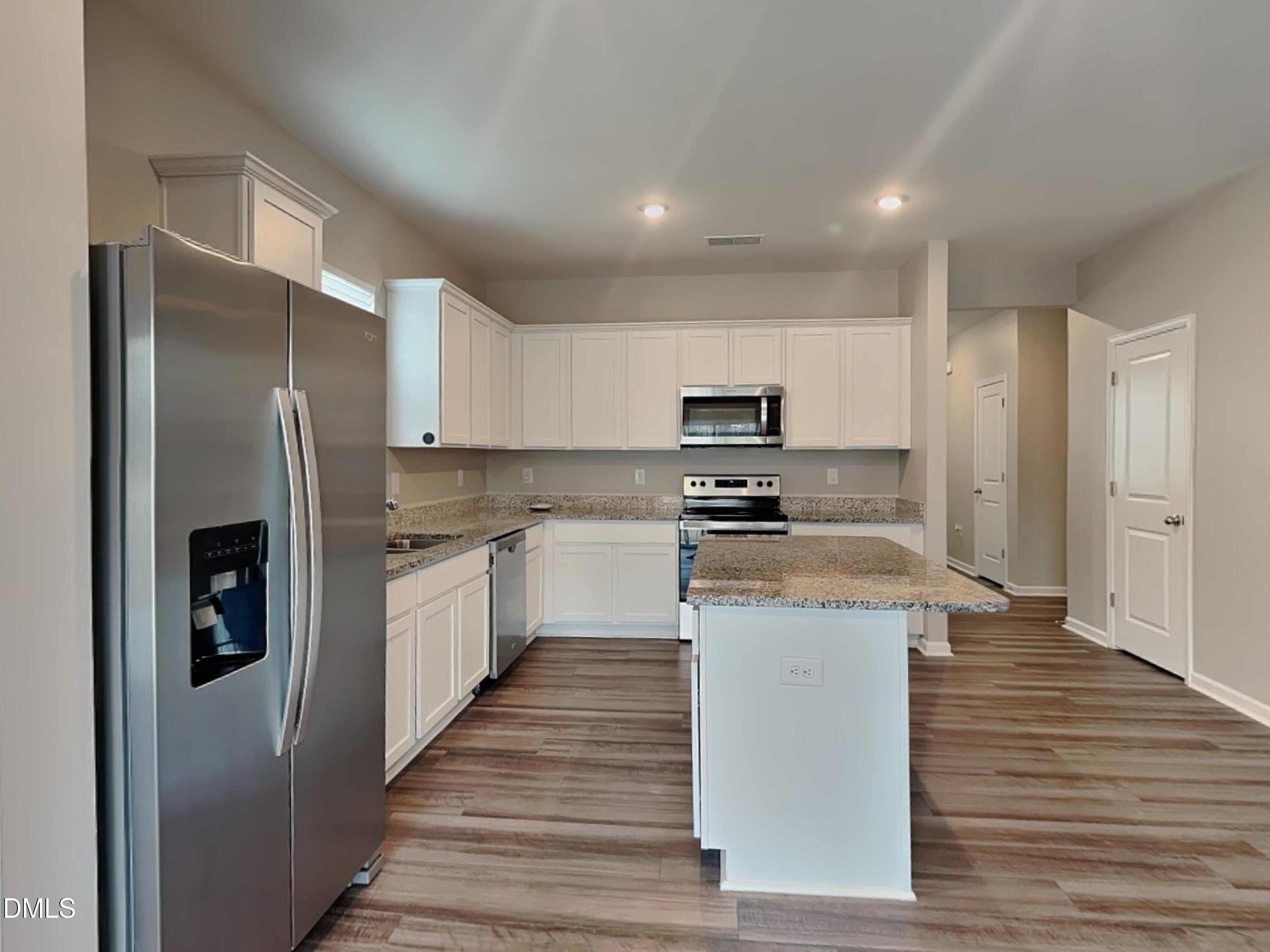 1416 Justice Union Court Raleigh, NC 27604 - Photo 5 of 16 a kitchen with stainless steel appliances granite countertop a refrigerator a stove and a sink