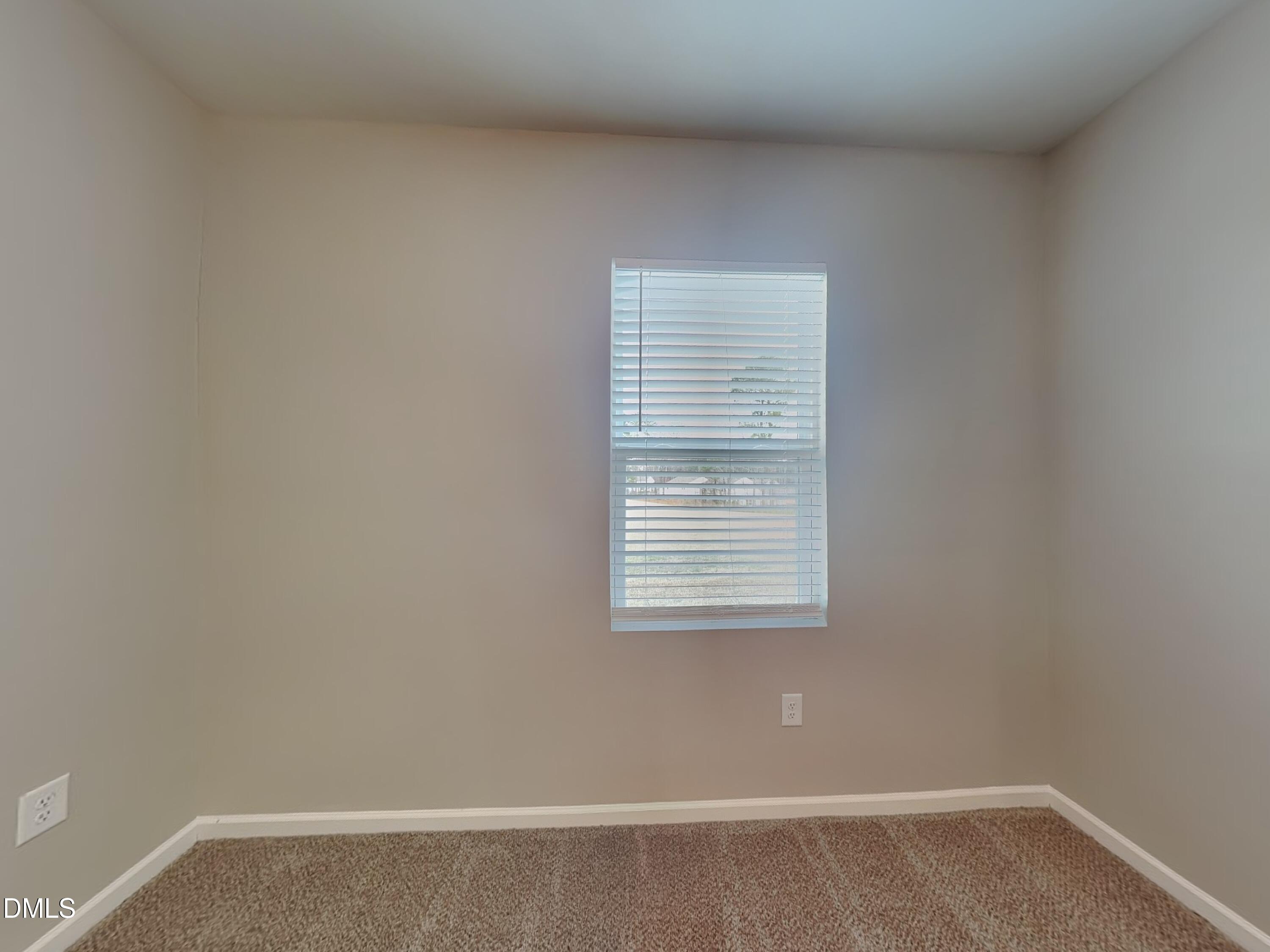 1416 Justice Union Court Raleigh, NC 27604 - Photo 8 of 16 a view of an empty room with wooden floor and a window