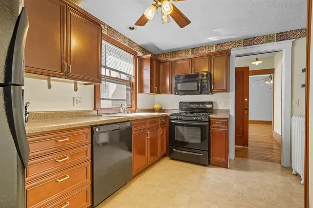 a kitchen with stainless steel appliances granite countertop a stove and a refrigerator