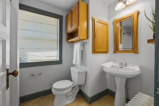 a bathroom with a sink toilet and mirror