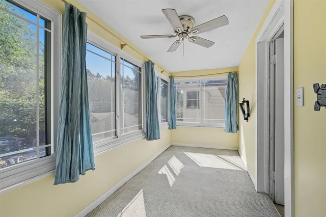 a view of hallway with livingroom and chandelier