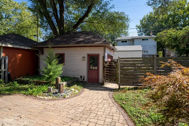 a view of a house with backyard and sitting area