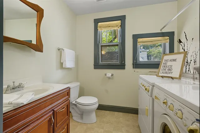 a bathroom with a sink a toilet and mirror