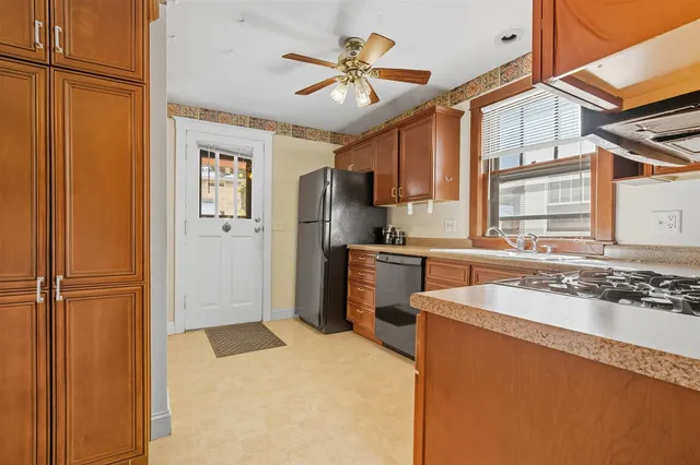 a kitchen with stainless steel appliances granite countertop a refrigerator a sink and dishwasher