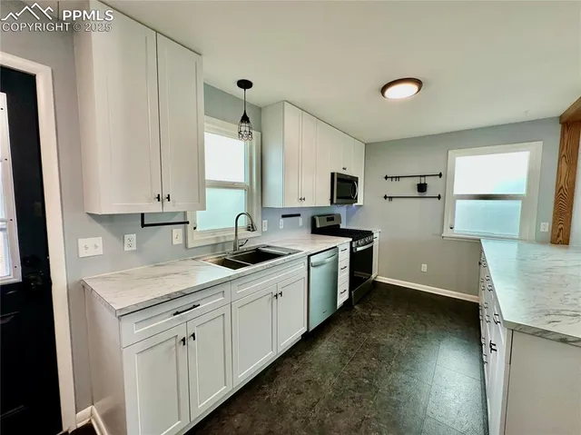 a kitchen with a sink stove and cabinets