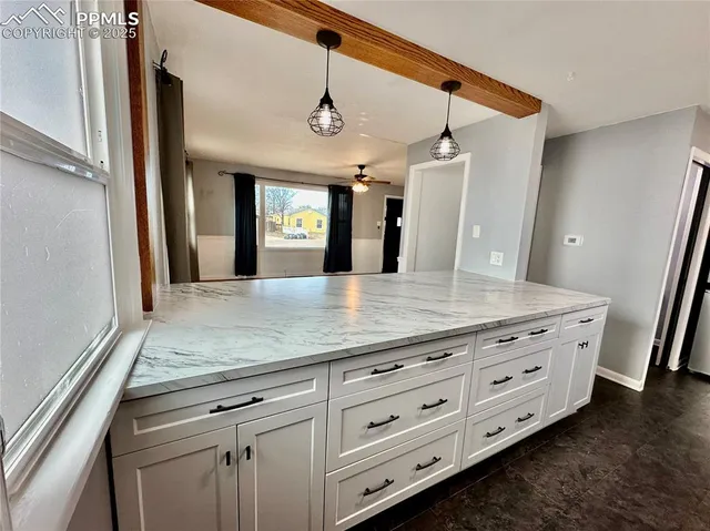 a bathroom with a granite countertop sink a mirror and vanity