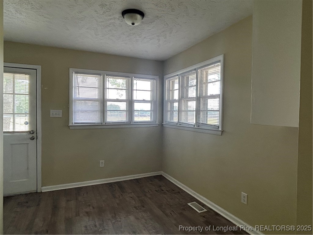 405 Chavis Street, Unit 8 Pembroke, NC 28372 - Photo 2 of 9 an empty room with a empty space and windows