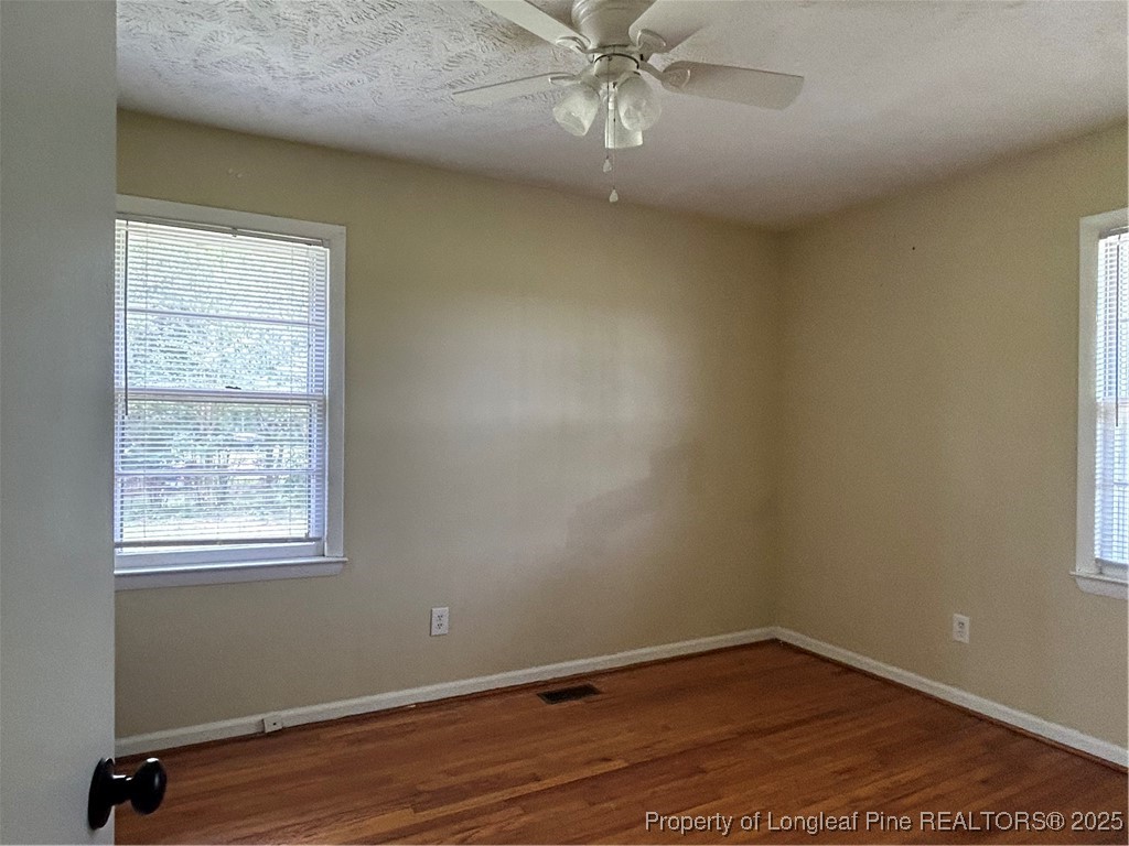 405 Chavis Street, Unit 8 Pembroke, NC 28372 - Photo 4 of 9 an empty room with wooden floor and windows