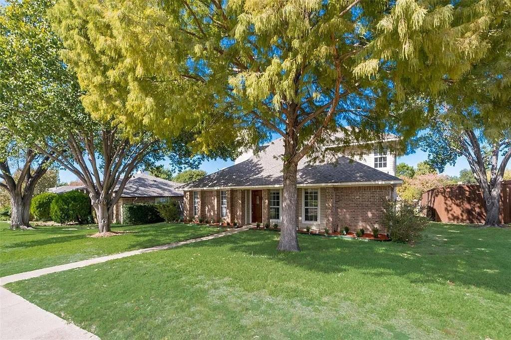 1202 Elder Carrollton, TX 75007 - Photo 1 of 1 a front view of a house with garden