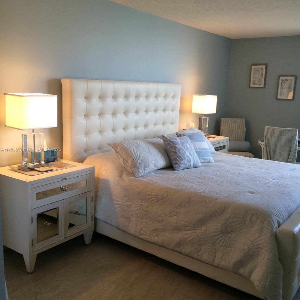 1340 South Ocean Boulevard, Unit 1003 Pompano Beach, FL 33062 - Photo 12 of 27 a bedroom with a bed and a couch