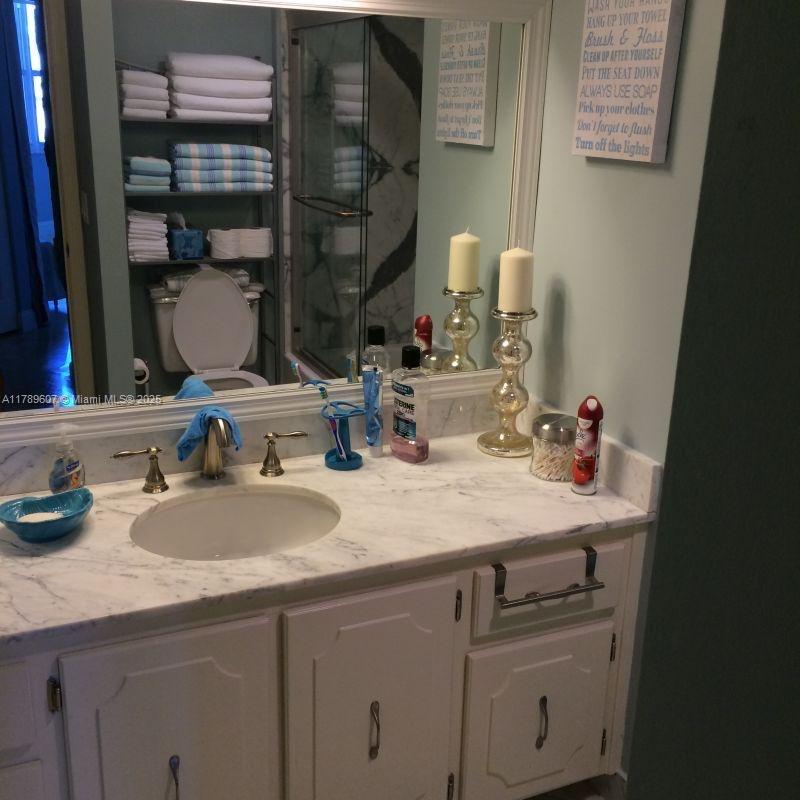 1340 South Ocean Boulevard, Unit 1003 Pompano Beach, FL 33062 - Photo 18 of 27 a bathroom with a sink and a mirror