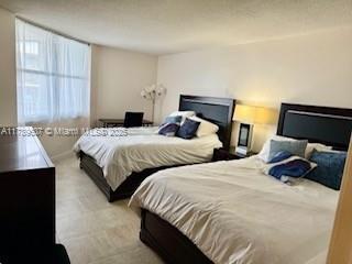 1340 South Ocean Boulevard, Unit 1003 Pompano Beach, FL 33062 - Photo 21 of 27 a bedroom with two beds and a window