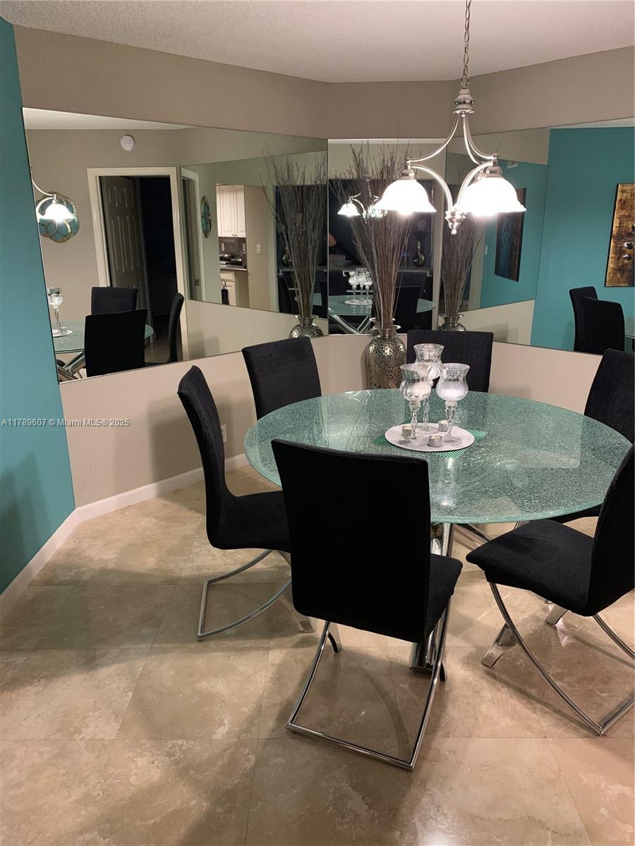 1340 South Ocean Boulevard, Unit 1003 Pompano Beach, FL 33062 - Photo 6 of 27 a view of a dining room with furniture