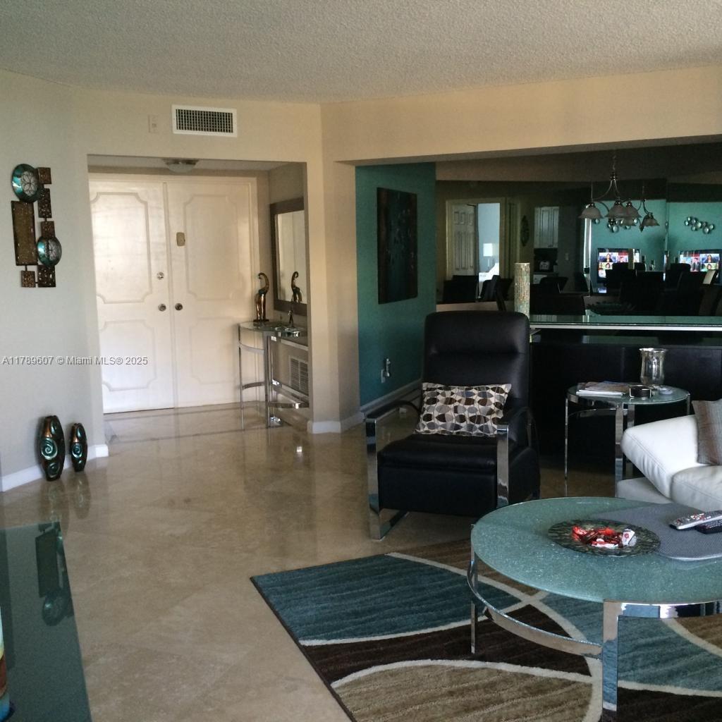 1340 South Ocean Boulevard, Unit 1003 Pompano Beach, FL 33062 - Photo 7 of 27 a living room with furniture and a table