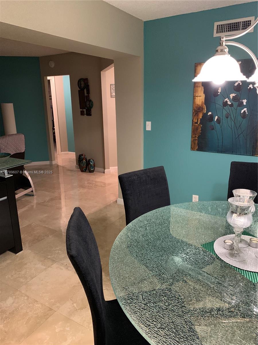 1340 South Ocean Boulevard, Unit 1003 Pompano Beach, FL 33062 - Photo 8 of 27 a kitchen with a sink and a mirror