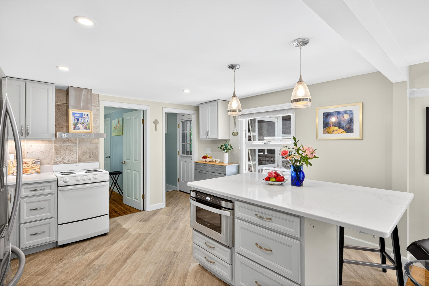 18 Seaview Road Sagamore Beach, MA 02562 - Photo 17 of 62 a kitchen that has a lot of cabinets stainless steel appliances and wooden floor