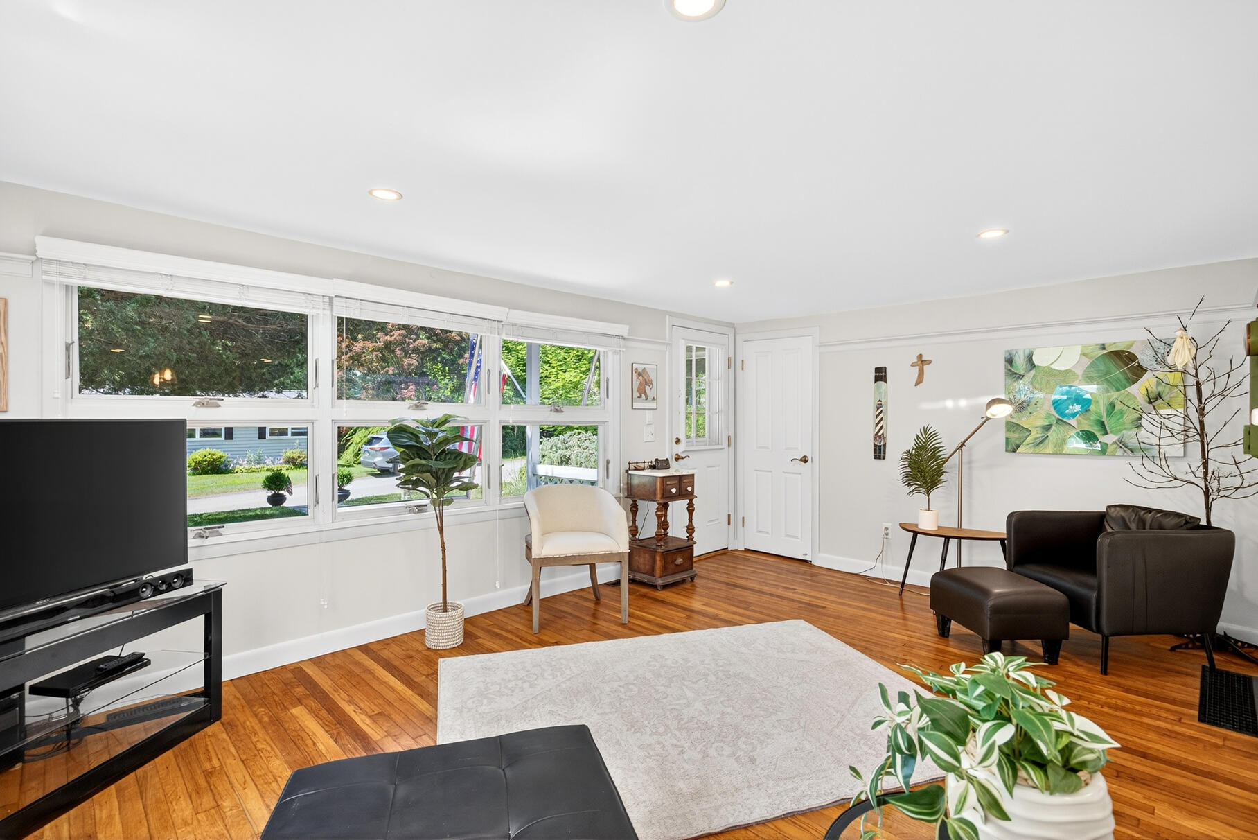 18 Seaview Road Sagamore Beach, MA 02562 - Photo 19 of 62 a living room with furniture a flat screen tv and a floor to ceiling window
