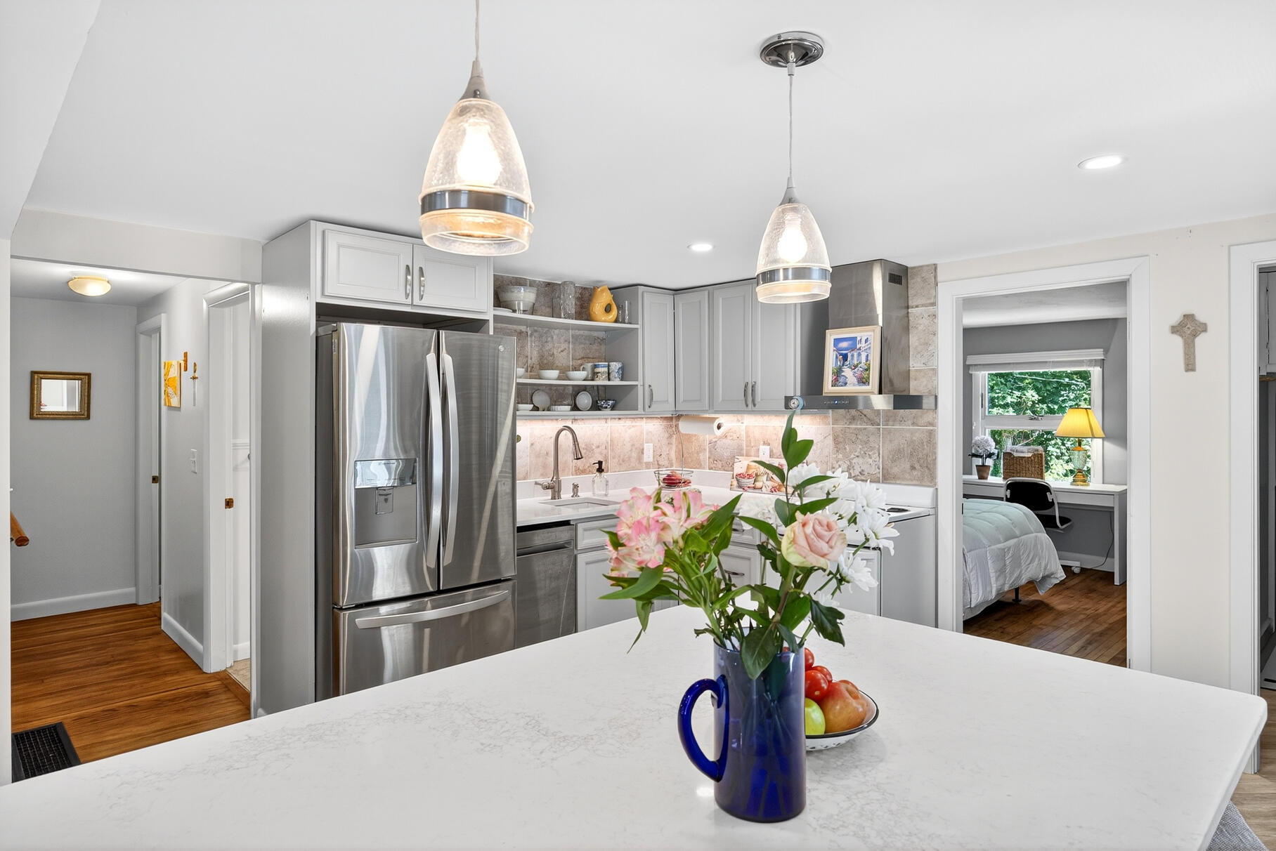18 Seaview Road Sagamore Beach, MA 02562 - Photo 20 of 62 a kitchen with stainless steel appliances a dining table chairs a chandelier and a view of living room