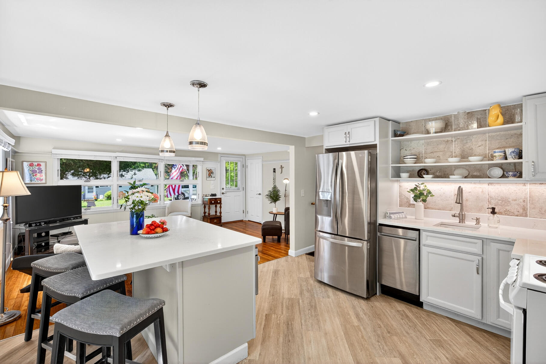 18 Seaview Road Sagamore Beach, MA 02562 - Photo 23 of 62 a kitchen with a refrigerator a stove and a dining table with wooden floor