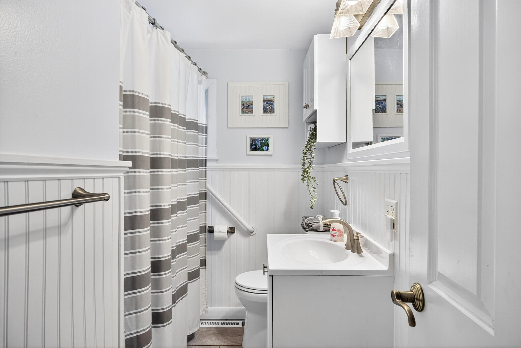 18 Seaview Road Sagamore Beach, MA 02562 - Photo 35 of 62 a bathroom with a sink a toilet and shower curtain